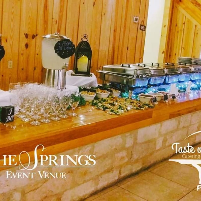 A buffet table with Mexican food, drinks, and chafing dishes at Taste of Mexico catering.