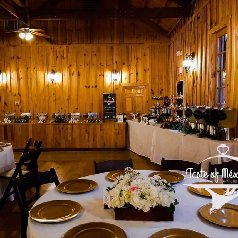 A Taste of Mexico buffet setup with chafing dishes, drink dispensers, and decorated tables.